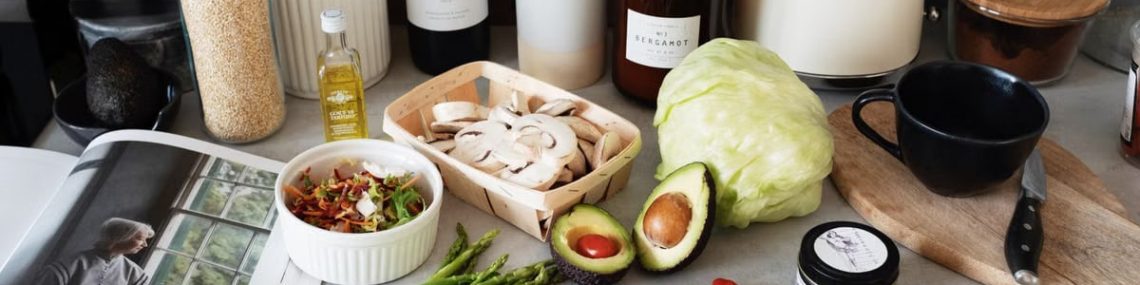 A variety of fresh ingredients and kitchen tools for preparing a healthy meal.